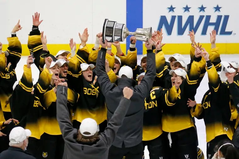 Boston Pride players cheer as coach Paul Mara hoists the NWHL's Isobel Cup in 2021. Boston will be among the six markets getting a Professional Women’s Hockey League team, with names and other details to be announced at a later date.