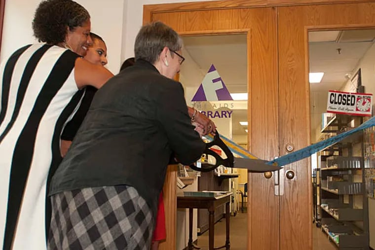 Eva Gladstein cuts the ribbon at the new BenePhilly Center on Locust Street near 12th, one of six in the city. (Ron Tarver/Staff)