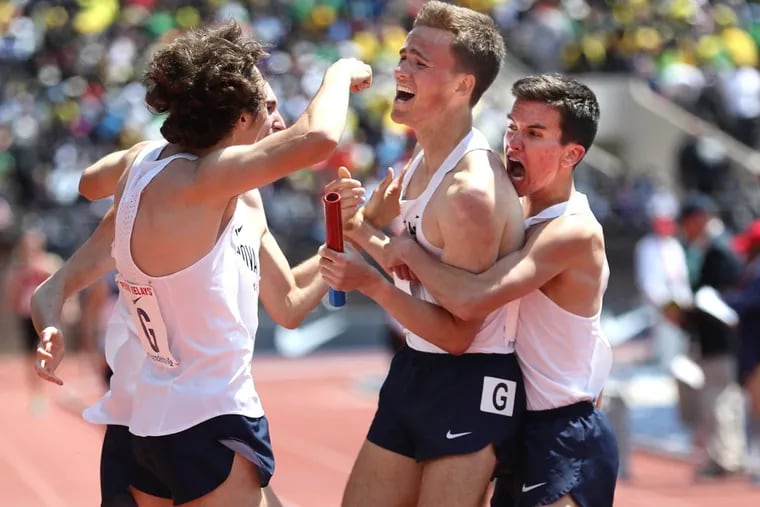 Villanova’s Casey Comber, center, is swarmed by teammates after they won the college men’s 4xmile Championship of America Invitational at the Penn Relays on April 28.