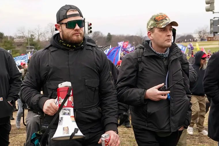 Philadelphia Proud Boys president Zachary Rehl (right) walks toward the U.S. Capitol in Washington, alongside Ethan Nordean. Both men face conspiracy charges along with two other leaders of the organization who prosecutors say led the group in storming the building Jan. 6.
