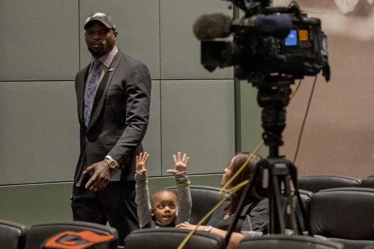 His three-year-old son Nazir Bradham reacts with his mom, Nia Davis, as Eagles linebacker Nigel Bradham arrives to talk to the media March 15, 2018 after the team re-signed him following their restructuring of Zach Ertz's contract, during free agency week. TOM GRALISH / Staff Photographer