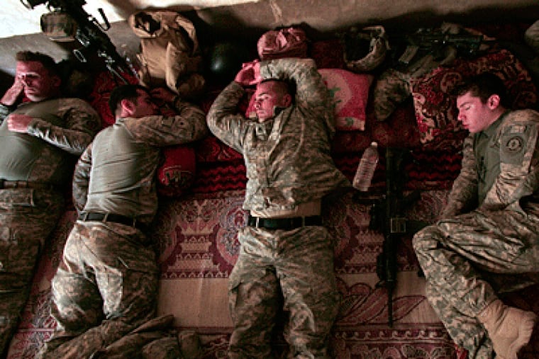 U.S. Army soldiers from Ghostrider Company, Third Squadron, Second Stryker Cavalry Regiment rest, during the midday heat as they occupy a house about 75 miles northeast of Baghdad on Monday. (AP Photo / Maya Alleruzzo)