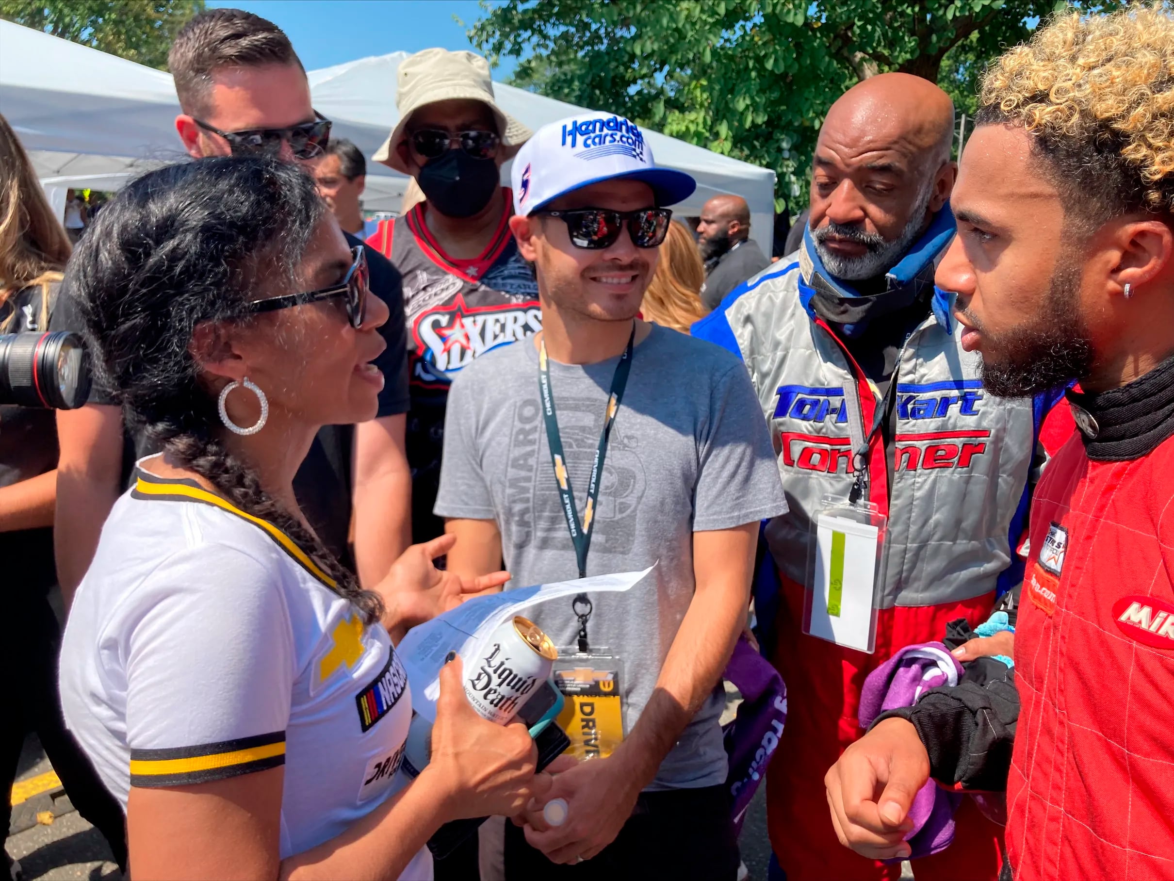 NASCAR driver Kyle Larson, center, talks with members of the Urban Youth Racing School before the start of a race on the grounds of the Please Touch Museum in Philadelphia on Friday. 