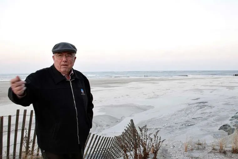 Jack Monaghan stands on the beach past his backyard in Strathmere. After a storm scoured away the sand, Monaghan asked the state to build a jetty at the mouth of Corson's Inlet to prevent further damage.