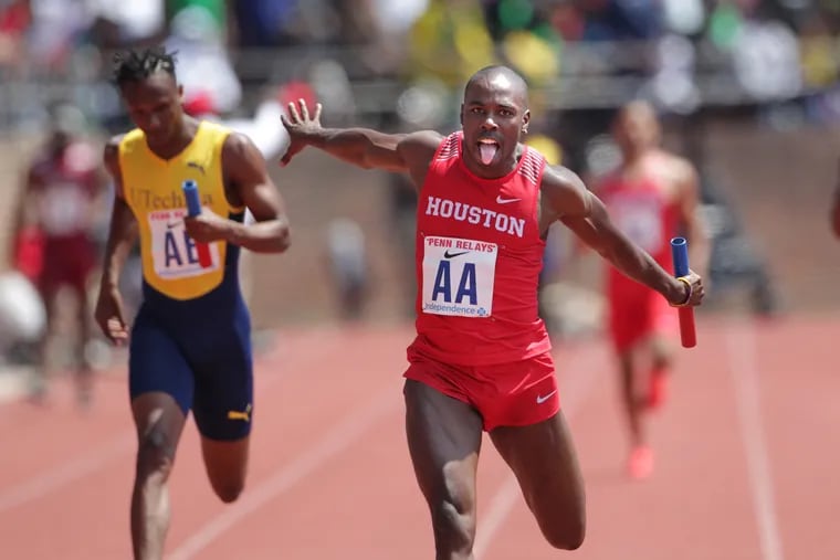 Cameron Burrell, right, of Houston reacts at the finish line as Houston wins College Men's 4x100 Championship of America at the Penn Relays on April 28, 2018.