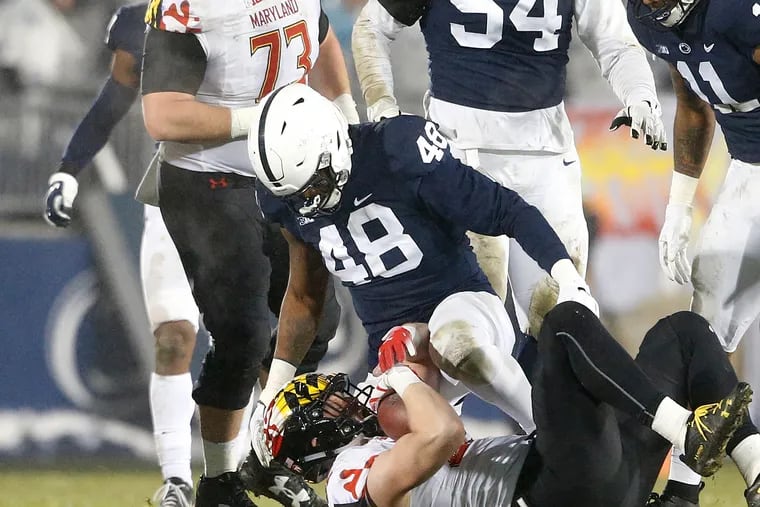 Penn State's Shareef Miller (48) drops Maryland's Avery Edwatds (82) for a loss during the second half of an NCAA college football game in State College, Pa., Saturday, Nov. 24, 2018. Penn State won 38-3.