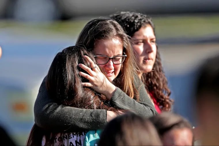 Students are released from a lockdown outside of Stoneman Douglas High School in Parkland, Fla., after a shooting on Wednesday.