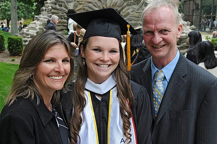 Charlene and Kevin Moran flank their daughter Emily who gave the 2014 commencement speech at La Salle University on May 18, 2014. Emily, who is from Drexel Hill and went to Archbishop Prendergast, played softball for La Salle. (Clem Murray/Staff Photographer)