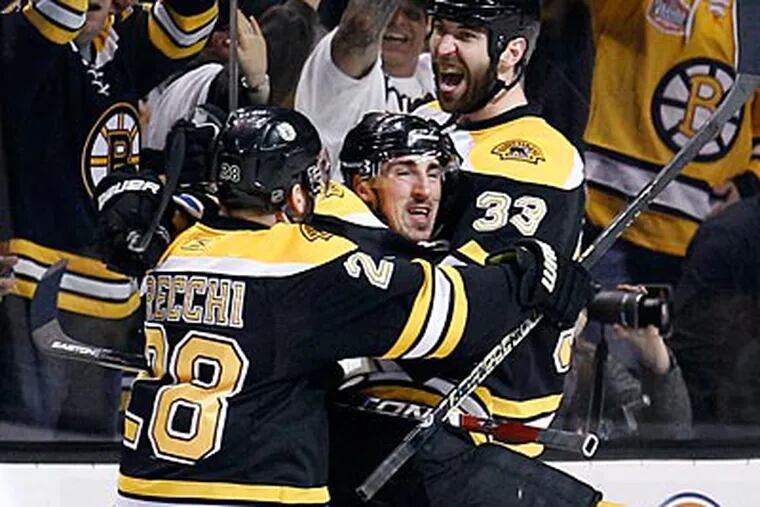 Bruins defenseman Zdeno Chara celebrates his first period goal with Brad Marchand and Mark Recchi. (Yong Kim/Staff Photographer)