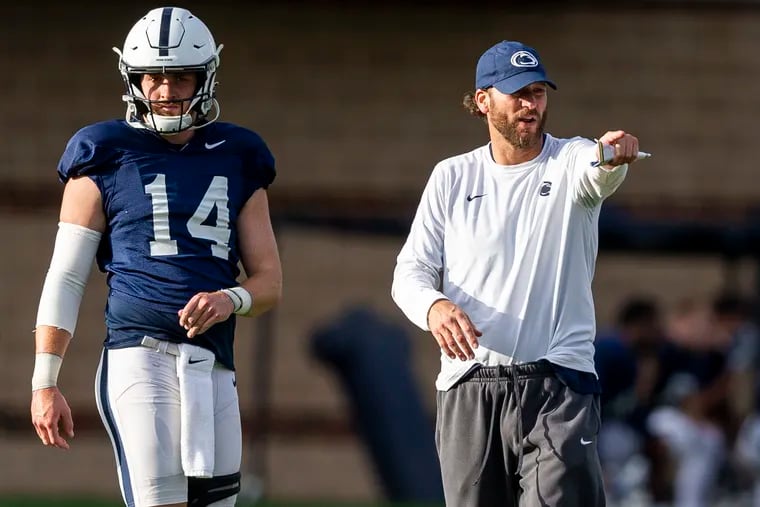 Penn State quarterback Sean Clifford (left) and offensive coordinator Mike Yurcich (right) during practice back in October. Both hope to return better in 2022 after the offense struggled this season.