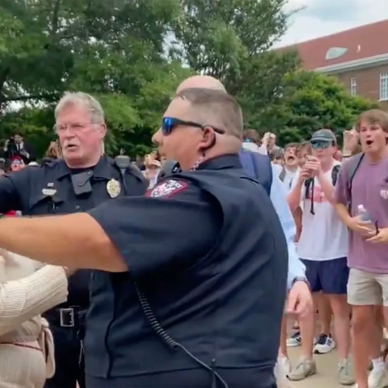 In this photo taken from video provided by Stacey J. Spiehler, a pro-Palestinian protester is confronted by hecklers at the University of Mississippi on Thursday. The hecklers vastly outnumbered pro-Palestinian demonstrators, and video shot by a student journalist showed one white heckler making monkey gestures and noises at a Black woman who was supporting pro-Palestinian protesters.