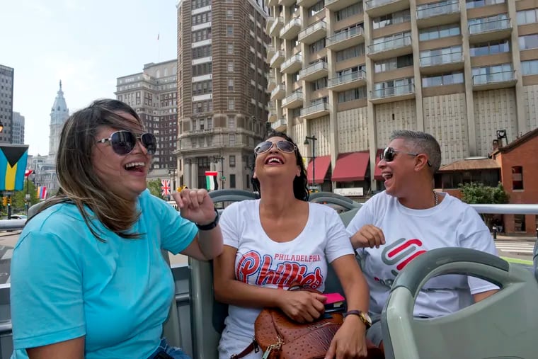 From left to right, Daisy Lopez, Carmen "Milly" Chevere Ortiz, and Soraida Perez, laugh while riding the Big Bus tour in Center City on August 6. In the aftermath of Hurricane Maria, Perez and Lopez met and forged a bond with Chevere Ortiz, a woman whose Puerto Rico neighborhood had been washed out by rising floodwaters. Nearly a year later, Chevere Ortiz visited Philadelphia, courtesy of Perez and Lopez.