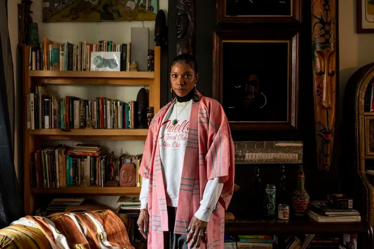 Tomarra Sankara-Kilombo, 31, of Akron, Ohio, poses for a portrait in her home which is filled with a collection of vintage pieces including art, books, and sculptures in Philadelphia's Germantown section on Friday. Sankara-Kilombo loved collecting items in general, but has more interest in Black culture. “I want people to know more about their culture,” Sankara-Kilombo said. “Educate people to appreciate their history and where they come from.”