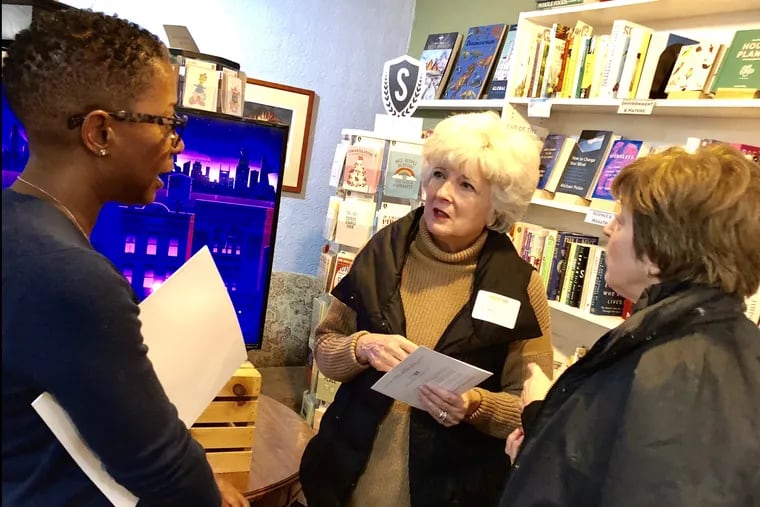 Kyle Ruffin, left, a founding member of Impact 100 South Jersey,  talks to new member Maggie McMahon, center, and returning member Nancy Mansfield during a recent information session at Inkwood Books in Haddonfield. The South Jersey group is part of an international grassroots movement of women's giving circles.