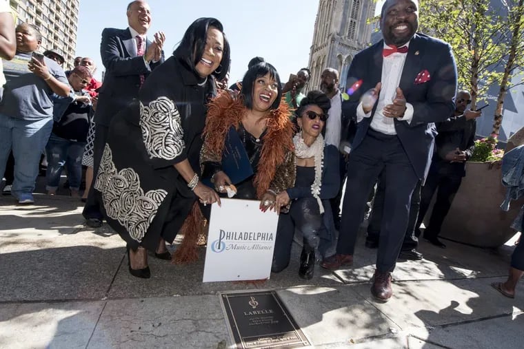 Sarah Dash (center) with Patti LaBelle to her right and Nona Hendryx to her left, as the members of Labelle unveiled their plaque on the Avenue of the Arts during a ceremony on Oct. 4, 2017. At left clapping is Councilmember Mark Squilla and at right is Councilmember Kenyatta Johnson.