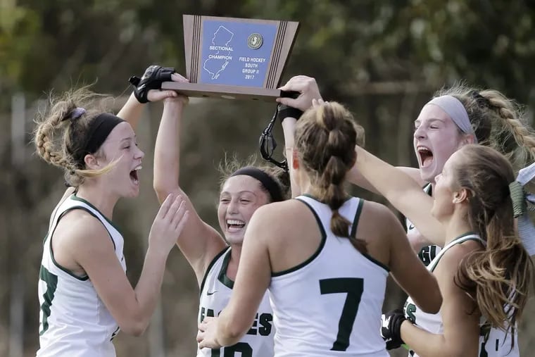 West Deptford’s Jessica McGivern holds up trophy after the Eagles won the S.J. 2 title with a 2-1 victory over Delsea.