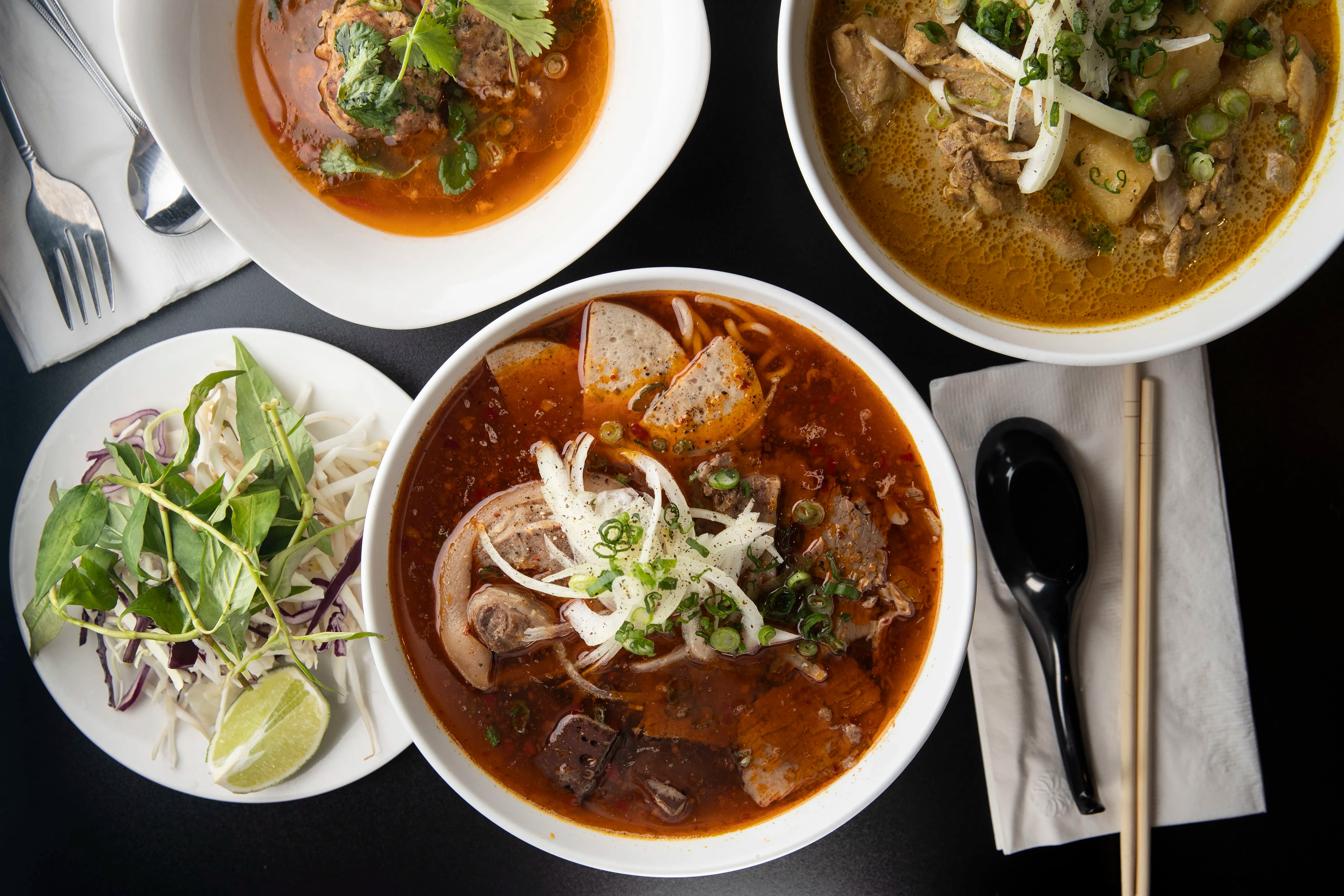 (left to right) The Banh Mi Xiu May, Bun Bo Hue Dac Biet and the chicken curry at Cafe Nhan in Philadelphia, Pa. on Monday, February 7, 2022. Cafe Nhan is located at 1606 W Passyunk Avenue.