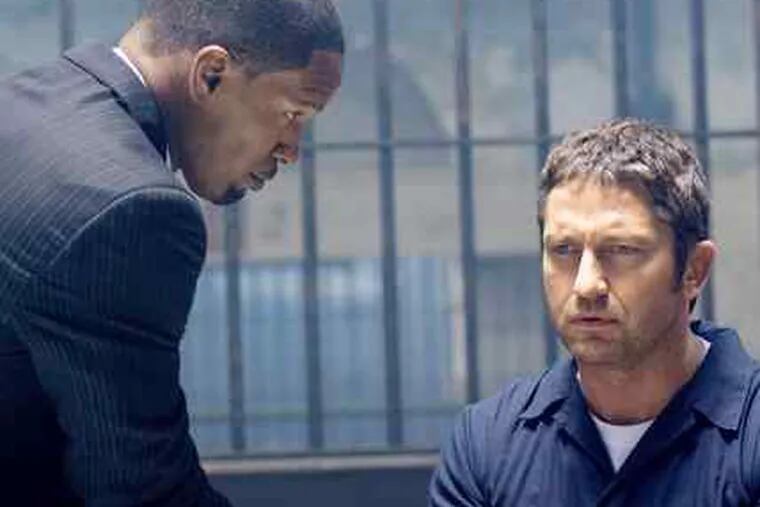 Law Abiding Citizen, with Jamie Foxx (far left) and Gerard Butler, isan ugly revenge fantasy that also paints an ugly picture of Philadelphia.