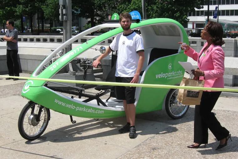 Councilwoman Blondell Reynolds Brown, who sponsored the legalization of bikecabs, with a model by Velo-Park, at a news conference on May 27, 2010.