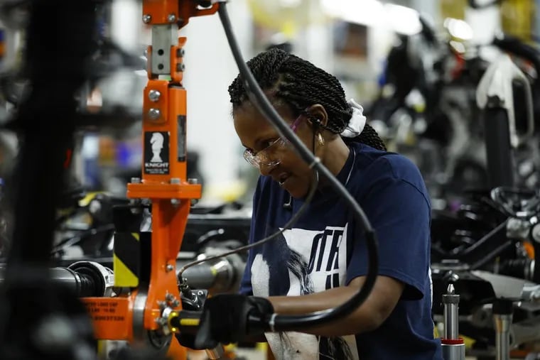 Workers on the assembly line at the Ford Chicago Assembly Plant where the Ford Explorer and Lincoln Aviator sport utility vehicles are worked on Monday, June 24, 2019. For the first time in nearly three years, Creighton University's nine-state Mid-America Business Conditions Index fell to 49.3 last month, below the threshold of 50, signaling economic contraction.