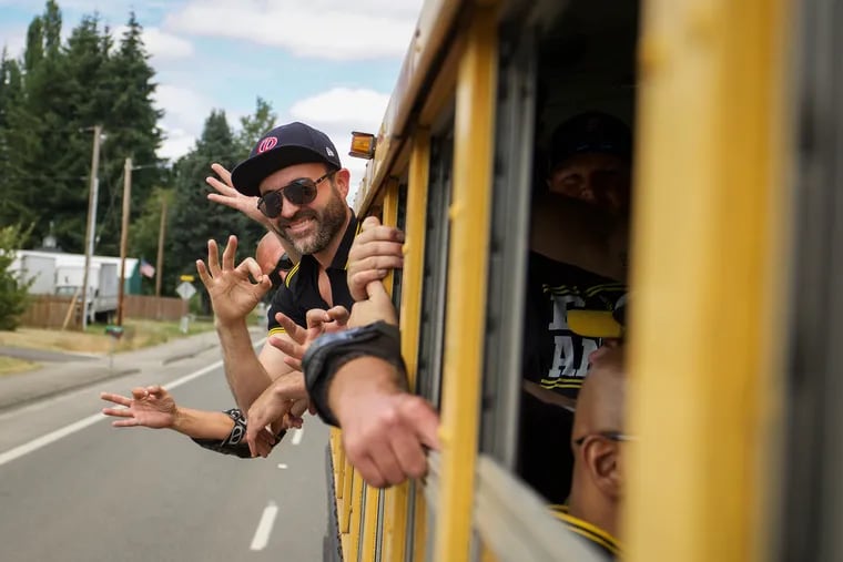 The Proud Boys make their signature hand symbol while riding to a rally in Portland, Oregon. They also use the signal to communicate with each other in the midst of a fray.