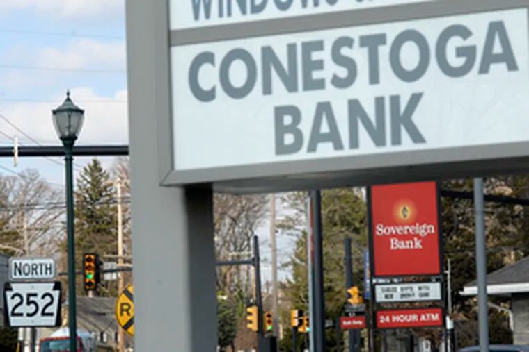 At the intersection of Route 252 and Baltimore Pike in Media, a Conestoga Bank is next door to a Sovereign Bank branch.