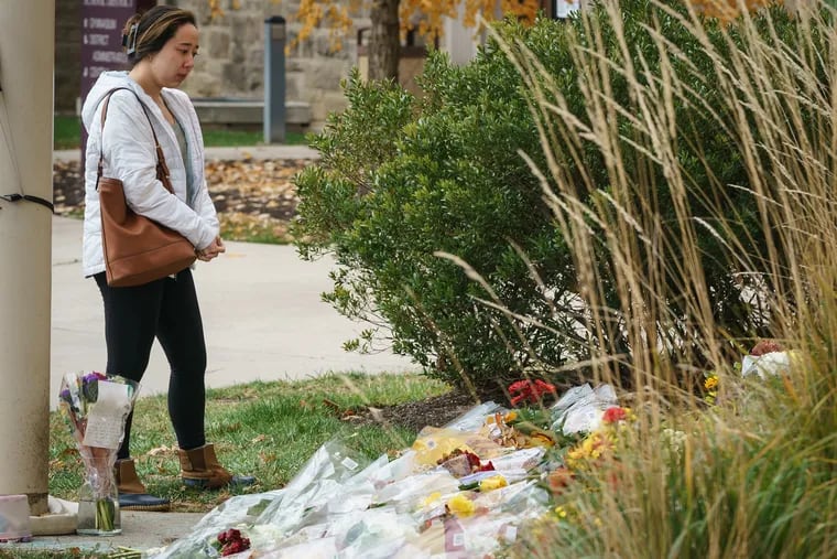 Kimberlyn McClendon, Class of 2015, takes a moment after dropping off flowers at a memorial for Principal Sean Hughes at Lower Merion High School. Principal Hughes was killed in an auto accident in New Jersey on Saturday.