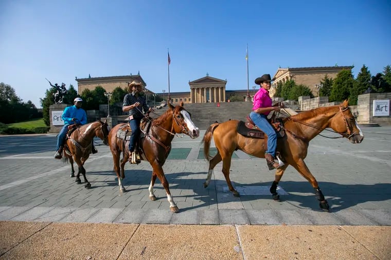 Chuck, center, ridden by Albert Lynch, in front of the Art Museum in 2020. Erin Brown, the Concrete Cowgirl (right) is riding Kidd. Steph Tolbert  (left) rides on Kowboy with a K.