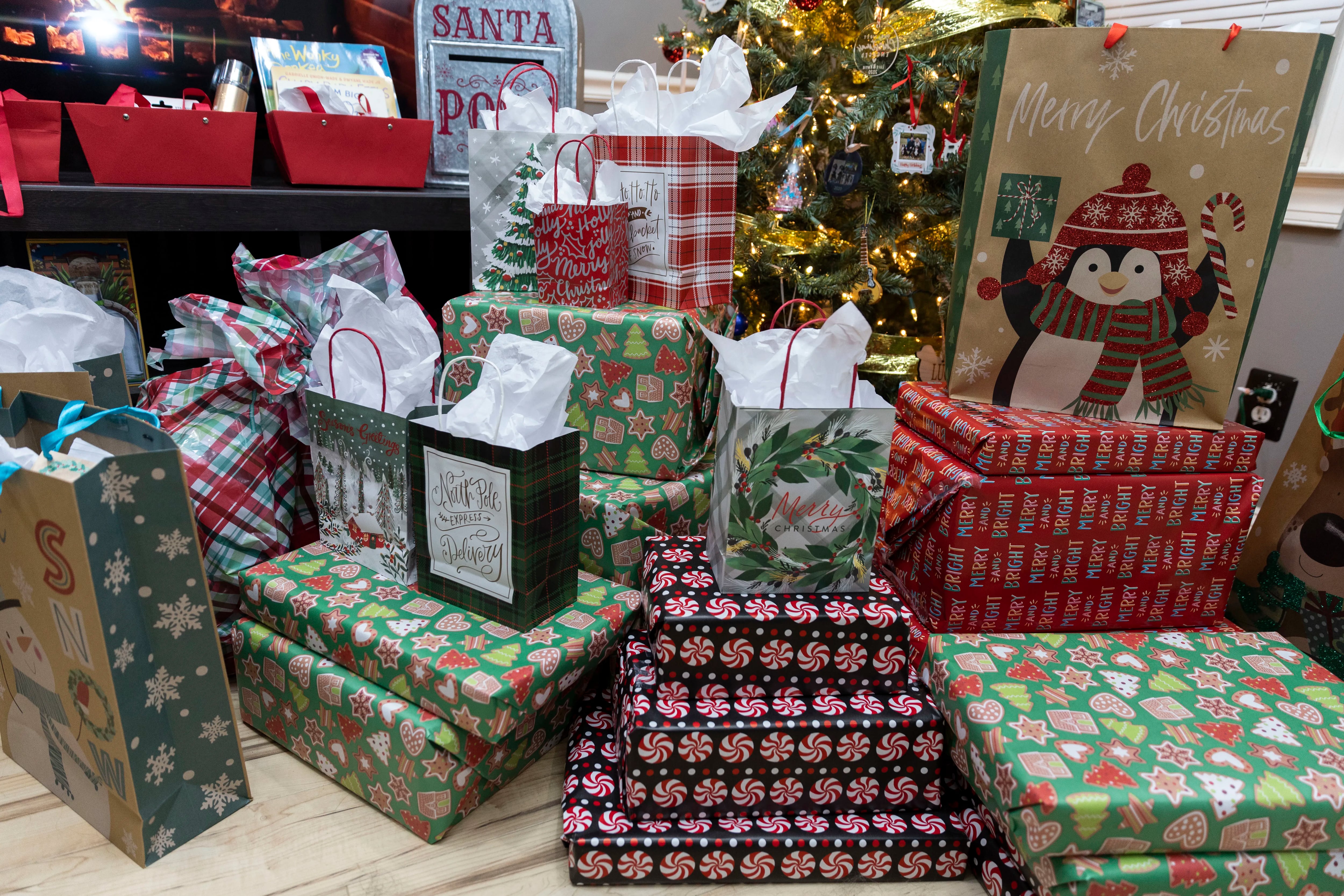 Wrapped presents were under the Christmas tree at the Garcia home in Bellmawr, N.J., on Monday, Nov. 27, 2023. They finish their holiday shopping by Labor Day. Experts say putting aside money months in advance can help you spend less come the holiday season.