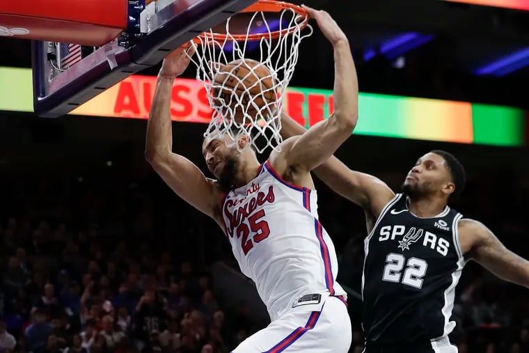 Sixers guard Ben Simmons dunks the basketball past San Antonio Spurs forward Rudy Gay during the third-quarter on Friday, November 22, 2019 in Philadelphia.