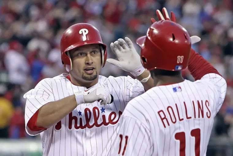 Shane Victorino is greeted at home plate by Jimmy Rollins after a home run during a May 2011 game at Citizens Bank Park. Victorino is returning to Philly to officially retire next month.