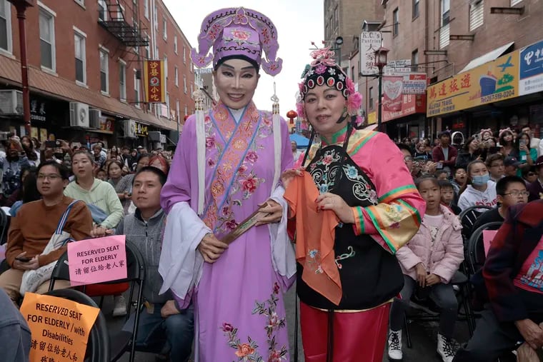 Mabel Chan (left) and Su Zhu Mai get ready to perform during the 28th annual Mid-Autumn Festival in Philadelphia’s Chinatown on Saturday. Chan said they were part of the Chinese Benevolent Association. The 28th annual Mid-Autumn Festival organized by Asian Americans United  featured musical performances, carnival games, and the popular mooncake-eating contest.