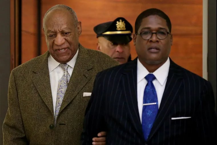 Actor and comedian Bill Cosby, left, walks into the courtroom with Andrew Wyatt, right for a pretrial hearing at the Montgomery County Courthouse in Norristown, PA on Monday, March 5, 2018.