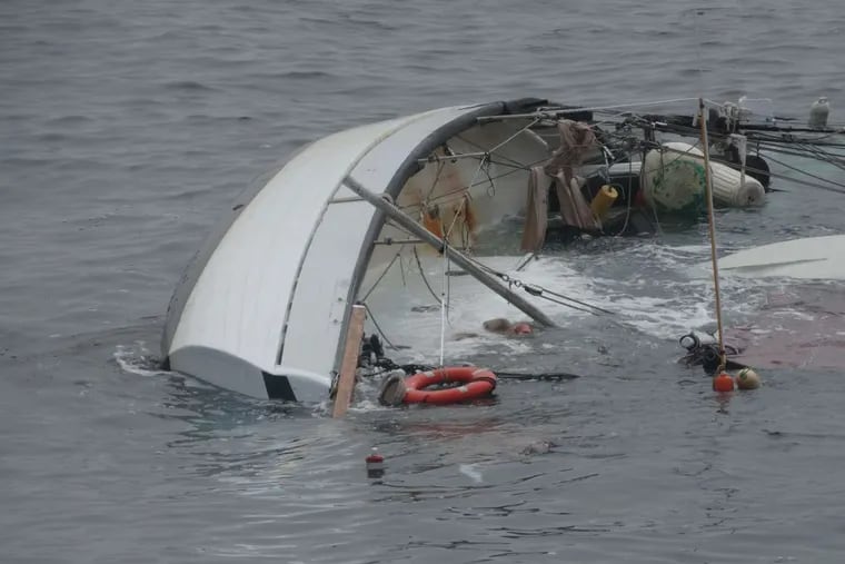 The Coast Guard rescued a man and woman who clung to the hull of this sailboat for about three hours after it capsized 65 miles off Atlantic City in rough weather Wednesday night.