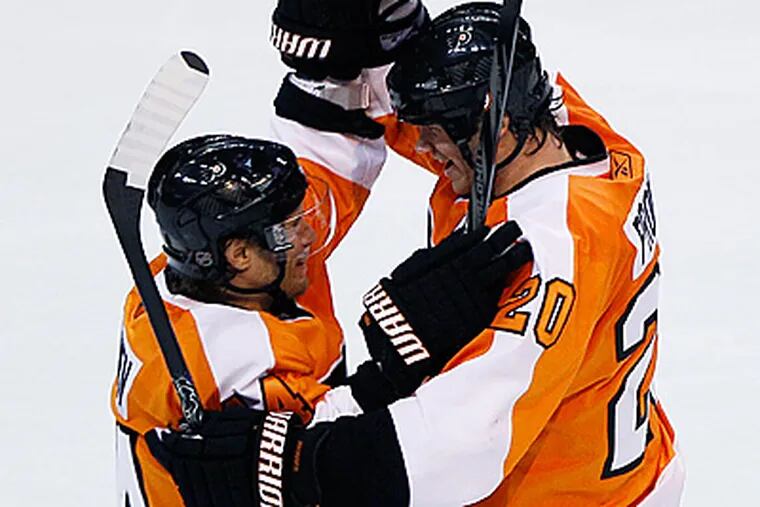 Chris Pronger, right, and Kimmo Timonen celebrate after Pronger's goal in the third period. (AP Photo/Matt Slocum)