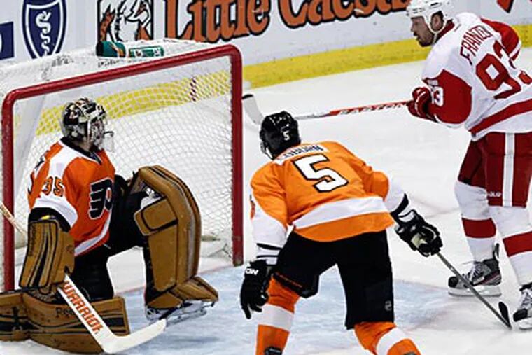 Red Wings forward Johan Franzen scores on Flyers goaltender Sergei Bobrovsky in the third period. (Paul Sancya/AP)