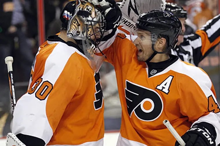 Ilya Bryzgalov and Kimmo Timonen hope to celebrate their eighth straight win today.  (Yong Kim / Staff Photographer)