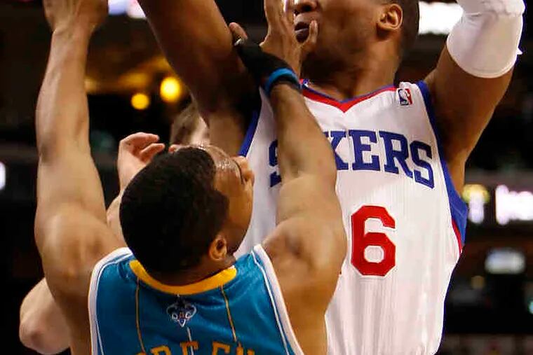 Marreese Speights is fouled by Hornets' Willie Green, a former Sixer, during yesterday's win.