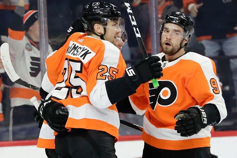 Flyers left wing James van Riemsdyk (25) celebrating his first-period goal Thursday night with teammates Ivan Provorov (9) and Tyler Pitlick during the team's 6-1 win over the Sabres.
