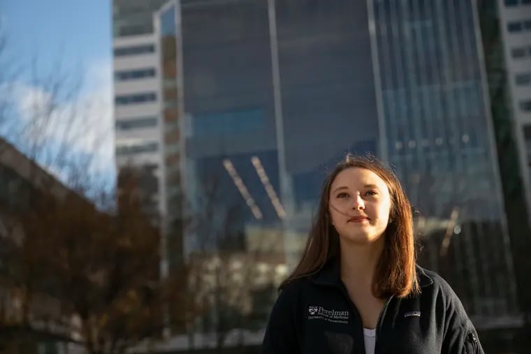 Olivia Palmer poses for a portrait  outside of the Perelman School of Medicine at Penn on Friday, Dec. 18, 2020. Palmer is a first-year medical student. She had already applied when the pandemic started, but the virus greatly impacetd her outlook on her career path.