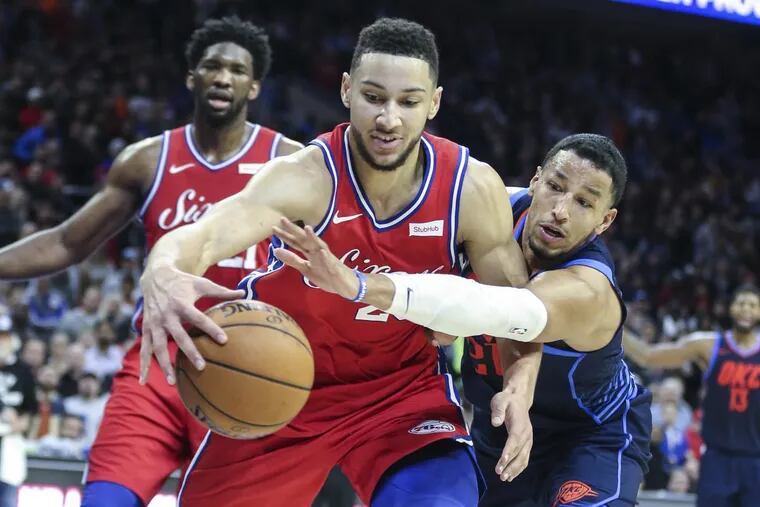 Sixers’ point guard Ben Simmons fights for a rebound against Thunder guard Andre Roberson on Friday.