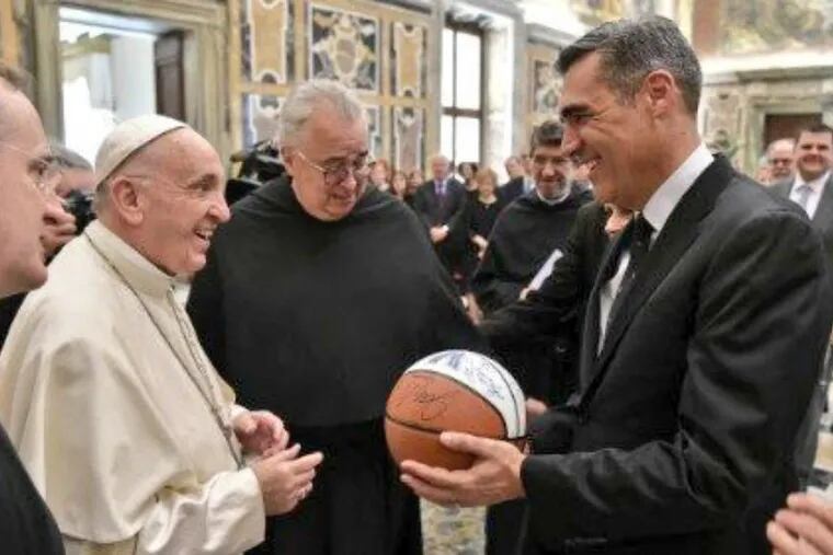 Pope Francis receiving the basketball autographed by the national-champion Villanova Wildcats from coach Jay Wright.