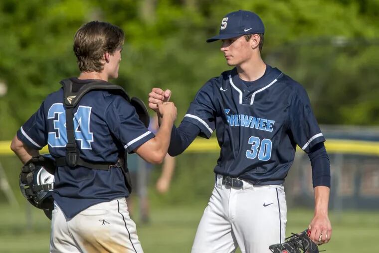 Shawnee starter Dan Frake (right) is congratulated by catcher Colin Wetterau (left) as he leaves the game after 4 2/3 strong innings in a 6-2 victory over Washington Twp. in the South Jersey Group 4 playoff opener.