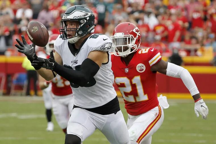 Eagles Zach Ertz, left, catches a deflected ball in front of the Chiefs’ Eric Murray, on Sept. 17.