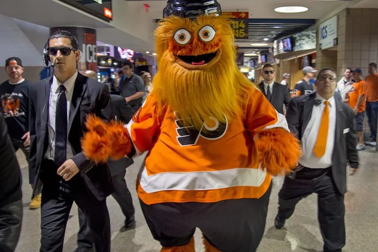 Gritty, the Flyers new mascot, walks through the crowd during the Flyers' home opener at the Wells Fargo Center last month.