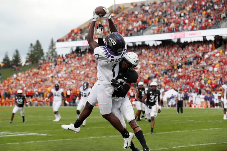 TCU wide receiver Jalen Reagor catches a 7-yard touchdown pass over Iowa State defensive back Anthony Johnson during a game last season. The Eagles selected Reagor in the first round of last month's NFL draft.