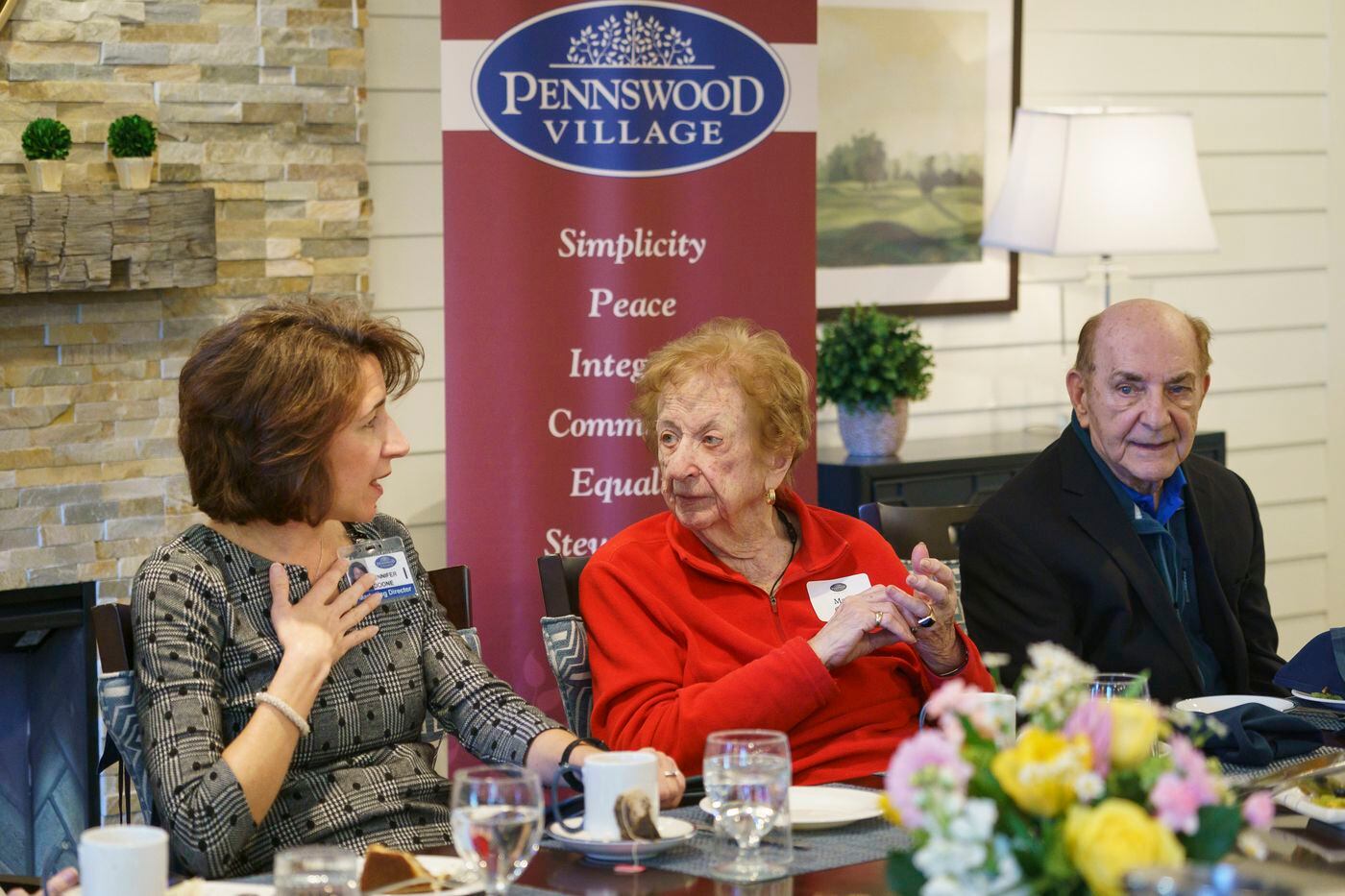 Jennifer Doone (left), marketing director, talks with potential resident, Mary O'Neil, at Pennswood Village in Newtown, as another visitor, William Berger, listens. 