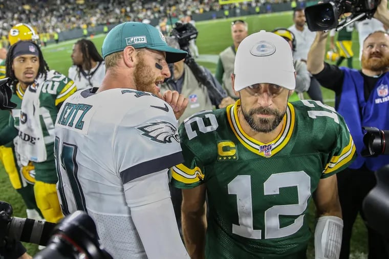 Eagles quarterback Carson Wentz, left, shared a moment with Packers quarterback Aaron Rodgers after last year's Eagles win at Lambeau.