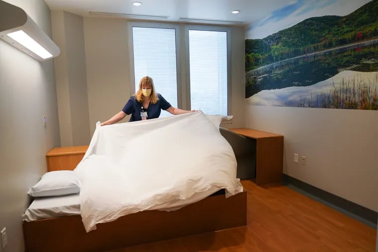 Heather Vince, BSN, RN, makes one of the beds in the newly expanded Inpatient Psychiatric Unit, as Main Line Health opened a new behavioral health unit at Bryn Mawr Hospital.