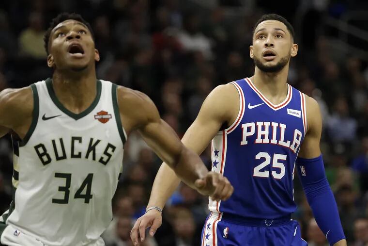 Milwaukee's Giannis Antetokounmpo (34) and the 76ers' Ben Simmons (25) during first-half action Wednesday night.